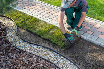 Landscaper laying sod